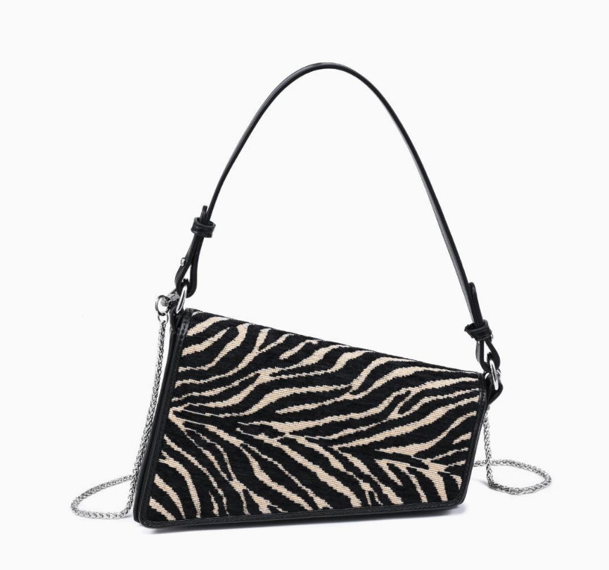 A zebra-print shoulder bag with black leather trim, a single top handle, and a silver chain strap, shown against a plain white background.