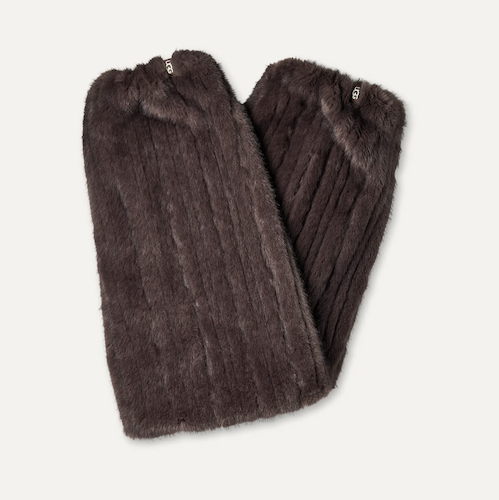 A pair of dark brown faux fur UGG leg warmers with vertical ribbed texture and small silver metal hardware, displayed on a light off-white background.