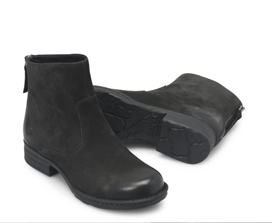 A pair of Born Mercado black ankle boots, one standing upright to show the side profile and zipper, and the other lying on its side to display the textured rubber sole, set against a plain white background.