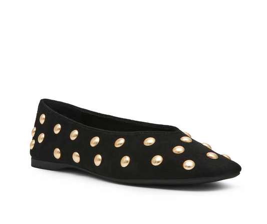 A black DV Karma flat shoe embellished with multiple round gold-tone studs, shown from a side profile on a clean white background.