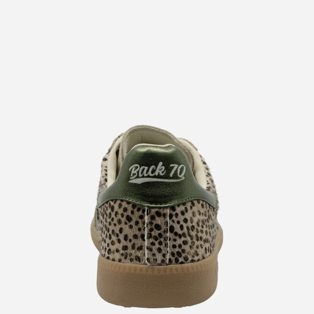 Rear view of a low-top Back 70 sneaker featuring a beige and black leopard print upper, a metallic olive green heel tab with 'Back 70' embroidered in white, and a tan gum sole.