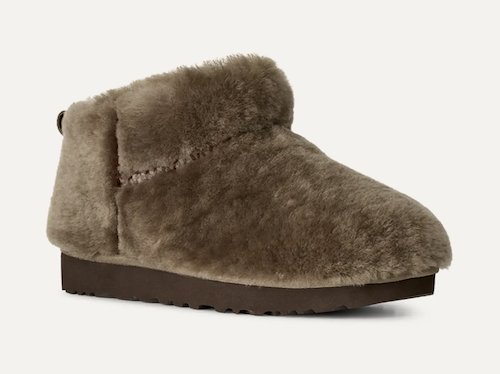 A single UGG Classic Ultra Mini taupe-brown shearling slipper boot with a dark brown sole, shown from a side profile on a light off-white background.