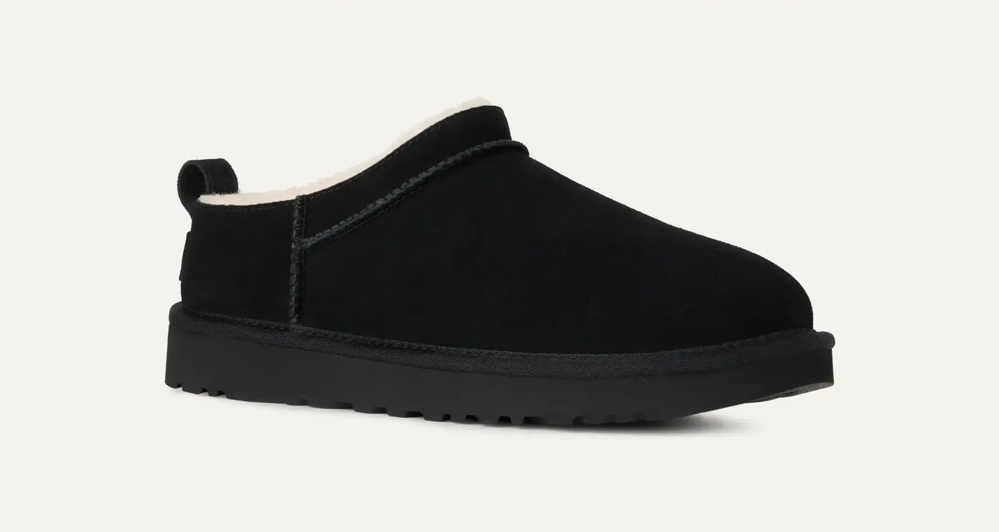 Women’s UGG Classic Micro Slipper in black suede with plush sheepskin lining and an ultra‑low silhouette.