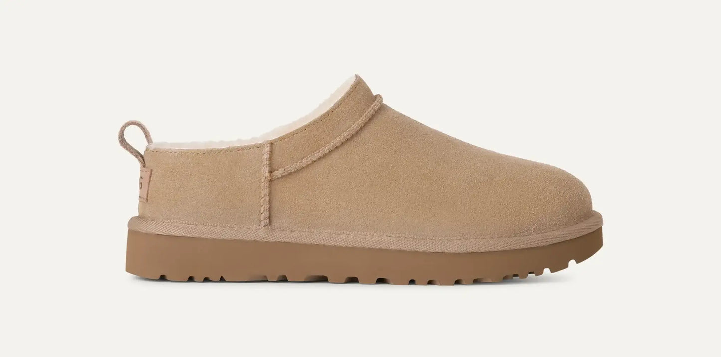 Women’s UGG Classic Micro Slipper in sand suede with plush sheepskin lining and an ultra‑low silhouette.