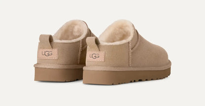 Women’s UGG Classic Micro Slipper in sand suede with plush sheepskin lining and an ultra‑low silhouette.