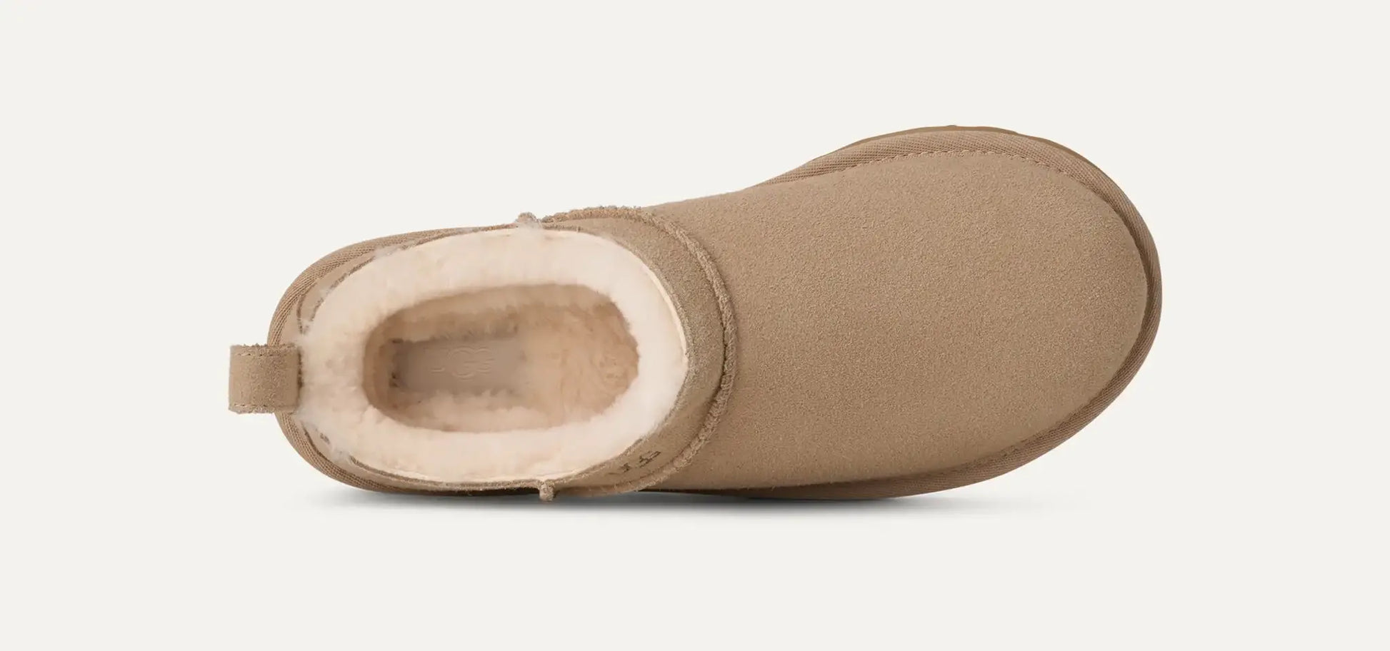 Women’s UGG Classic Micro Slipper in sand suede with plush sheepskin lining and an ultra‑low silhouette.