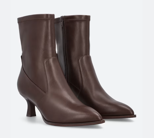 A pair of DV Lalana dark brown leather ankle boots with a pointed toe, mid-height kitten heel, and side zipper, shown against a light gray background.