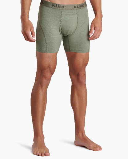 A man wearing Kühl men's boxer briefs in a heathered sage green color, shown from the waist down against a plain white studio background.