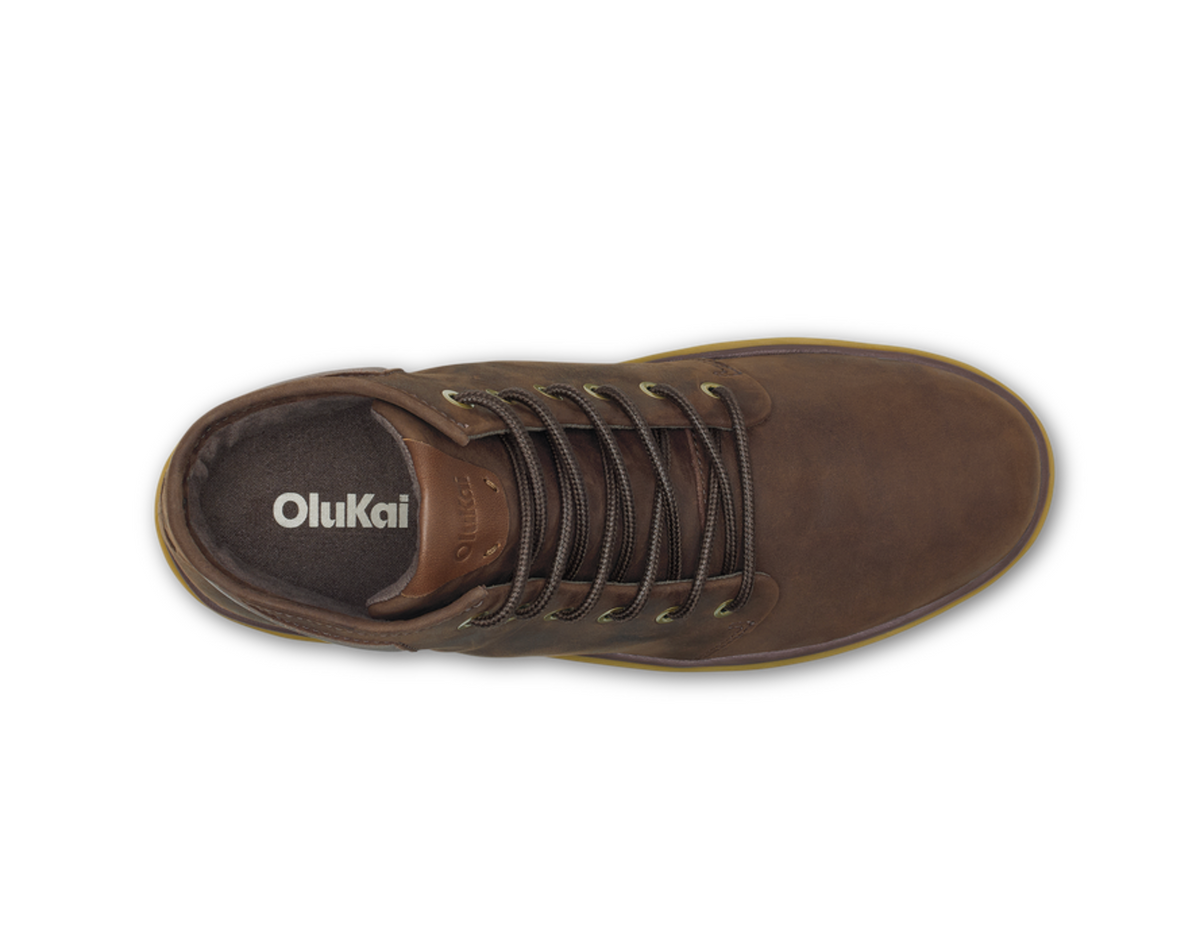 A single Olukai Kekana brown leather lace-up shoe shown from a top-down view on a white background, with the brand name 'OluKai' printed on the black insole.