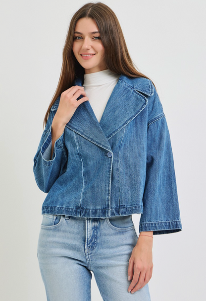 Risen cropped medium‑blue wash denim jacket with soft‑stretch fabric and button‑front styling.