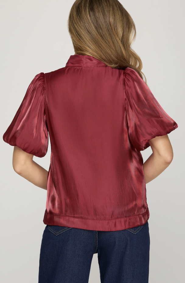 She & Sky red woven top with feminine bow detail and smooth draped silhouette.