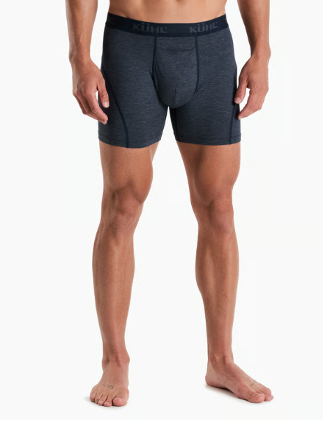 A man wearing dark heather gray boxer briefs with a black waistband featuring the KUHL brand logo, shown from the waist down against a plain white background.