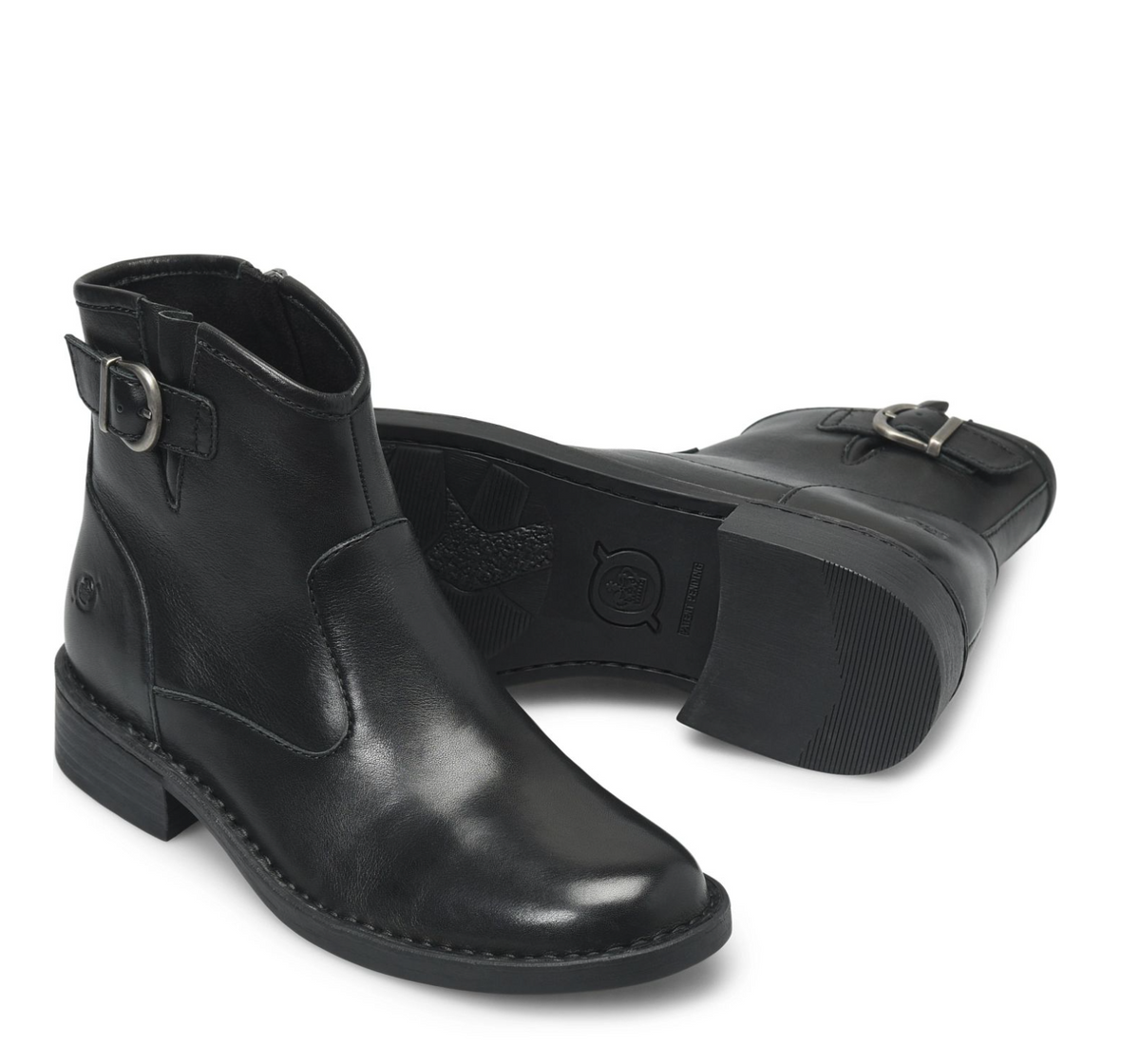 A pair of black leather Born Charlie ankle boots with silver buckle details, shown on a clean white background.