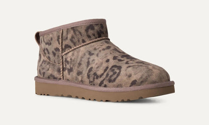 A single UGG Classic Ultra Mini  ankle-height slip-on boot with a brown and beige leopard print pattern, a tan sole, and a matching pull tab, shown against a plain off-white background.