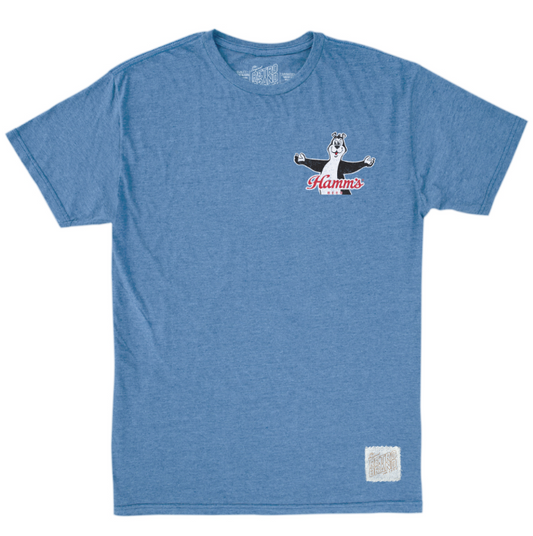 A heather blue short-sleeve t-shirt with a small graphic on the left chest featuring a cartoon bear and the text 'Hamm's Beer'. A small white woven label is visible near the bottom right hem.