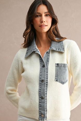 A woman wearing a Mable cream ribbed knit cardigan with a gray denim-style collar, front placket, and chest pocket, posed against a plain beige studio background.