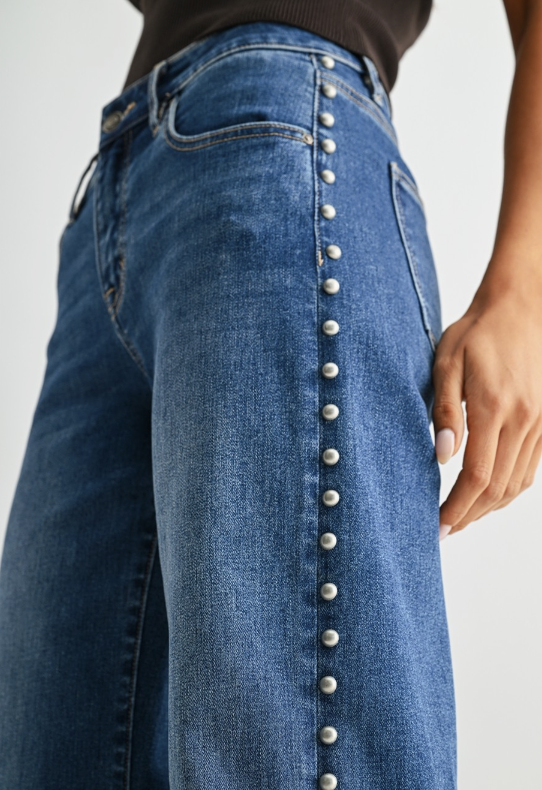 Medium blue wash wide‑leg studded jeans with soft‑stretch denim and polished‑edgy detailing.