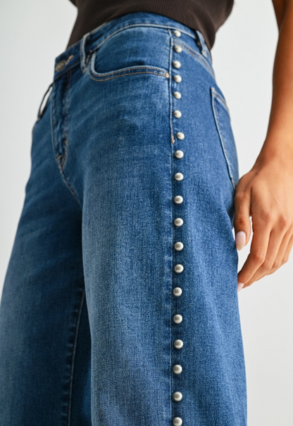 Medium blue wash wide‑leg studded jeans with soft‑stretch denim and polished‑edgy detailing.