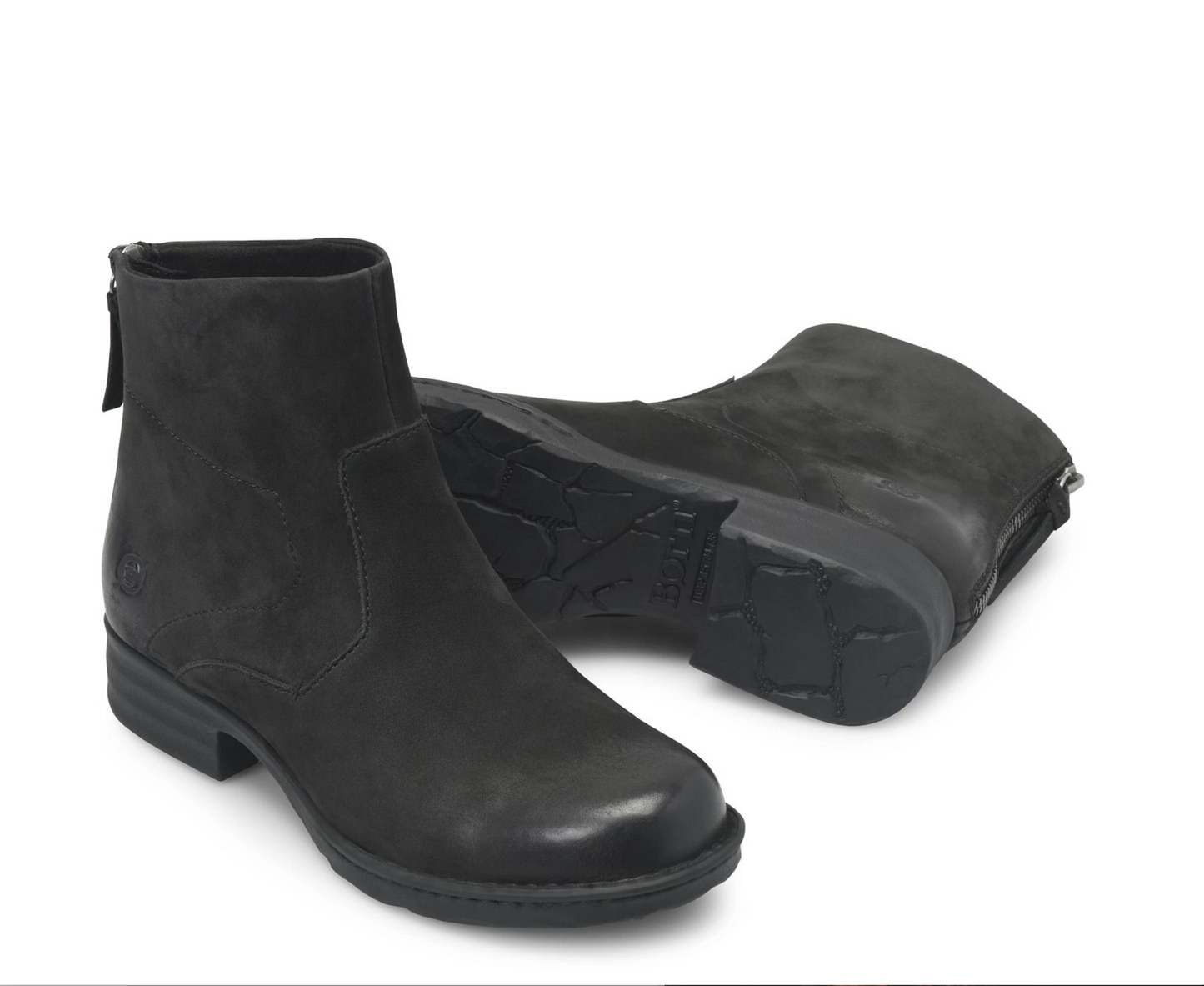 A pair of Born Mercado black ankle boots, one standing upright to show the side profile and zipper, and the other lying on its side to display the textured rubber sole, set against a plain white background.