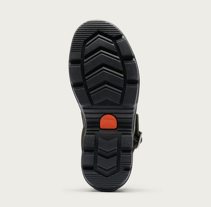 The black rubber outsole of a Sorel Roam’n Clog, shown from a top-down view against a light beige background. The sole features a deep chevron tread pattern and a small, bright orange circular brand patch in the center.