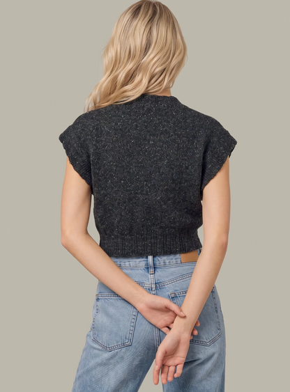 A woman shown from the back wearing a dark charcoal gray short-sleeve 525 America knit sweater and light blue jeans against a solid light gray background.