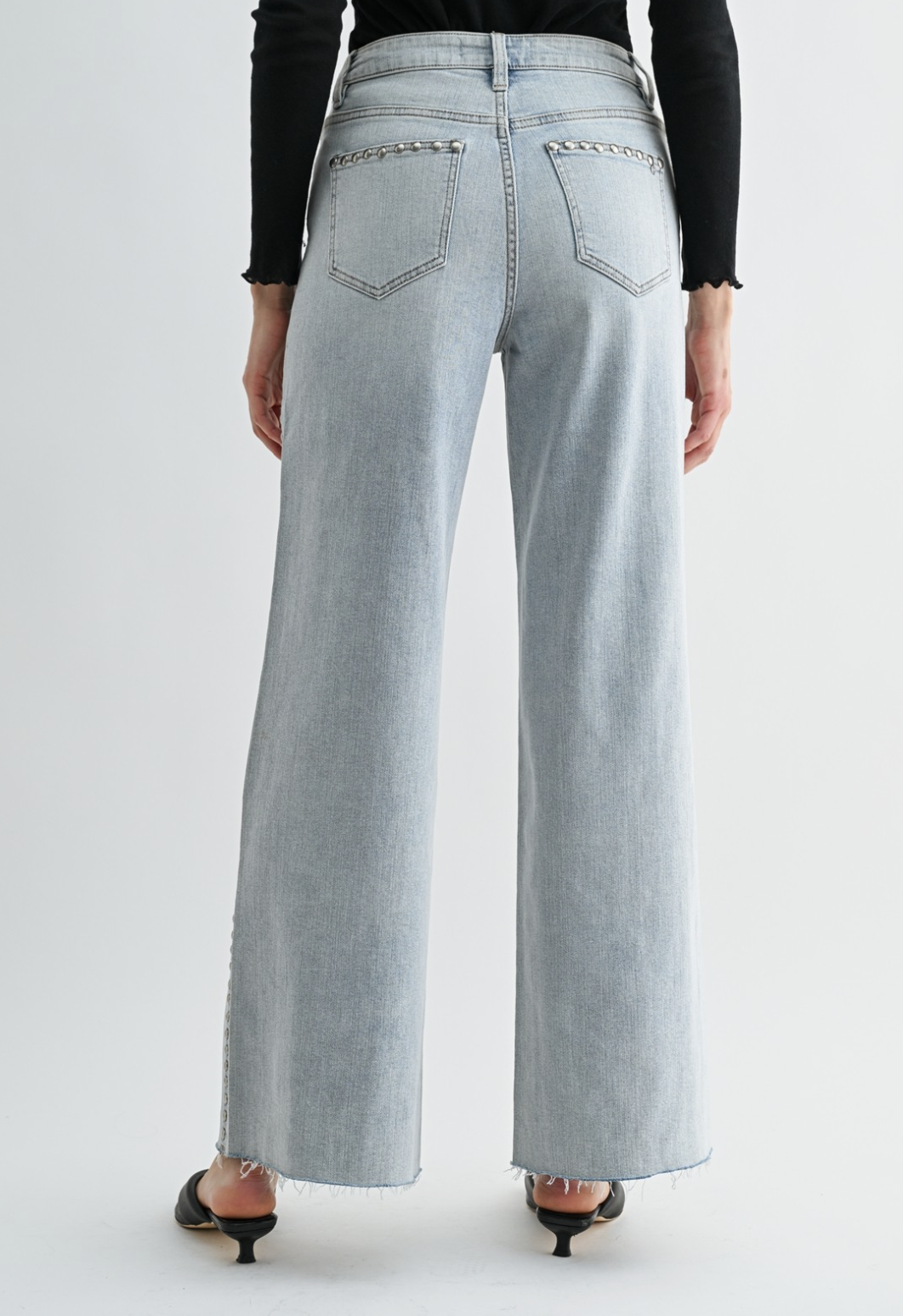 Neptune‑wash raw‑hem studded jeans with soft‑stretch denim and polished‑edgy detailing.