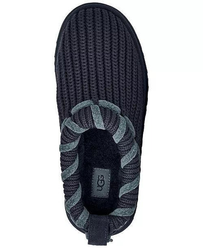 A single UGG  Tazz Whipstitch slip-on slipper shown from a top-down view, featuring a dark navy blue ribbed knit upper, a gray and navy twisted rope detail around the collar, and a black UGG logo patch on the inner sole.
