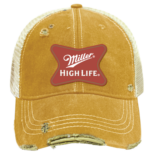 A distressed yellow trucker hat with a red Miller High Life patch on the front, featuring cream mesh back panels and simulated wear details.