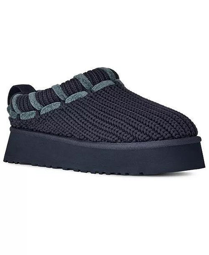 A single UGG Tazz Whipstitch slip-on knit slipper in a very dark navy blue, featuring a thick matching platform sole and contrasting textured knit details around the collar, shown on a plain white background.