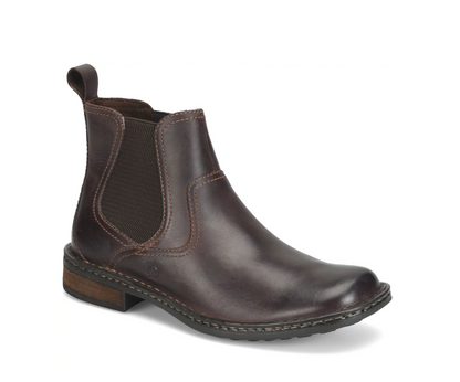 A dark brown leather Chelsea boot with a black elastic side panel, shown from a three-quarters angle on a white background.