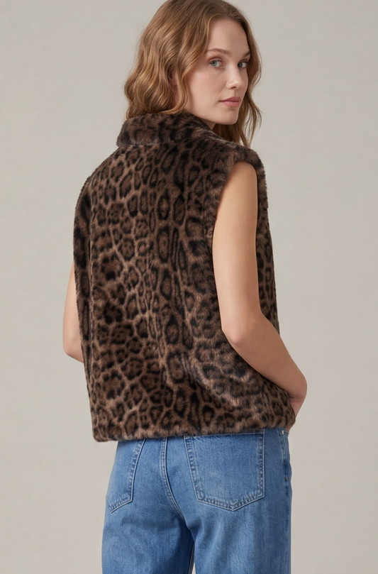 A woman wearing a brown and black leopard-print faux fur sleeveless vest, shown from a three-quarter back view against a neutral light gray background.