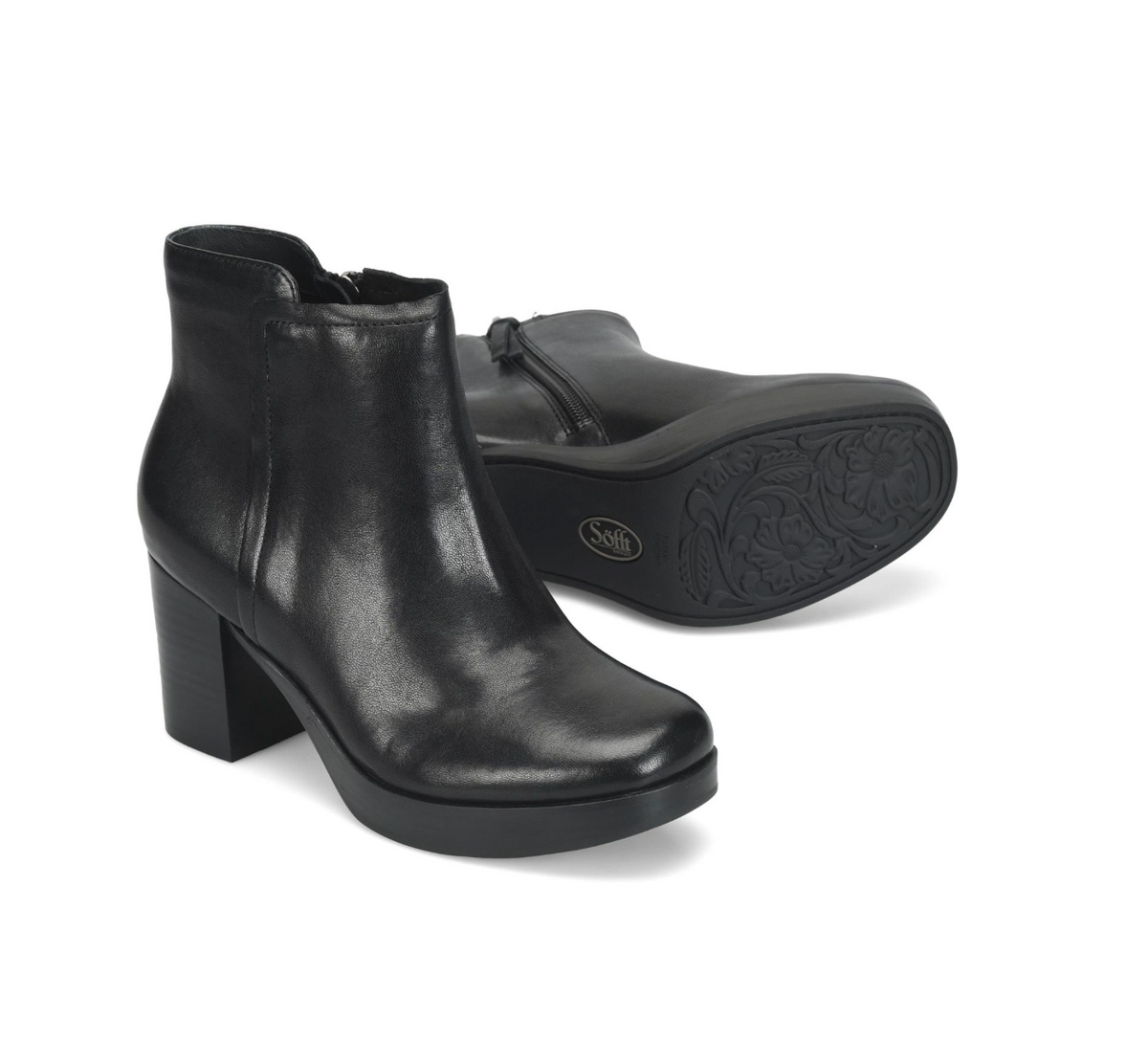 A pair of black leather Sofft Kendall  ankle boots with block heels, shown on a clean white background. One boot is positioned upright to show the side profile, while the other lies on its side to display the sole and embossed floral pattern.
