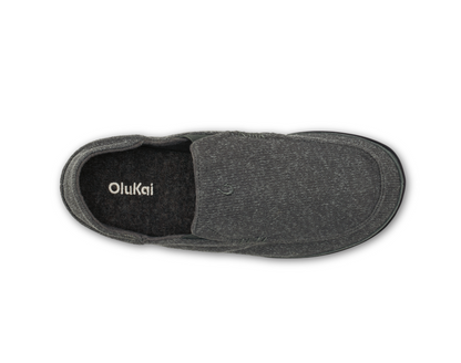 A single Olukai Moloa Hulu dark gray slip-on shoe shown from a top-down view on a white background, with the brand name 'OluKai' printed on the black inner sole.