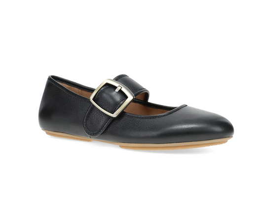 A Dansko black leather Mary Jane flat shoe with a silver-tone metal buckle strap, shown from a side profile on a white background.