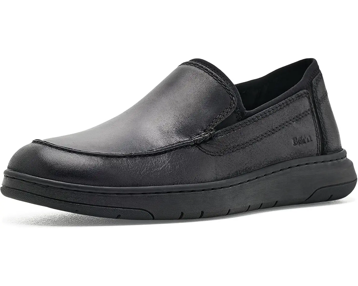 A single black Born slip-on leather shoe with a thick black sole, shown from a side profile on a white background.