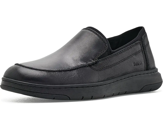 A single black Born slip-on leather shoe with a thick black sole, shown from a side profile on a white background.