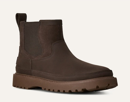 A dark brown UGG Birch Chelsea-style ankle boot with a thick lug sole, shown from a side profile on a light off-white background.
