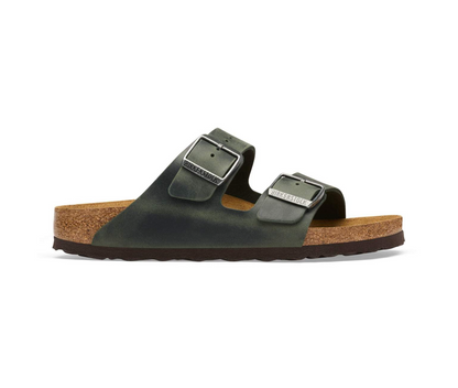 A pair of Birkenstock Arizona sandal in thyme with two straps and contoured cork footbed, shown from a side profile on a white background.