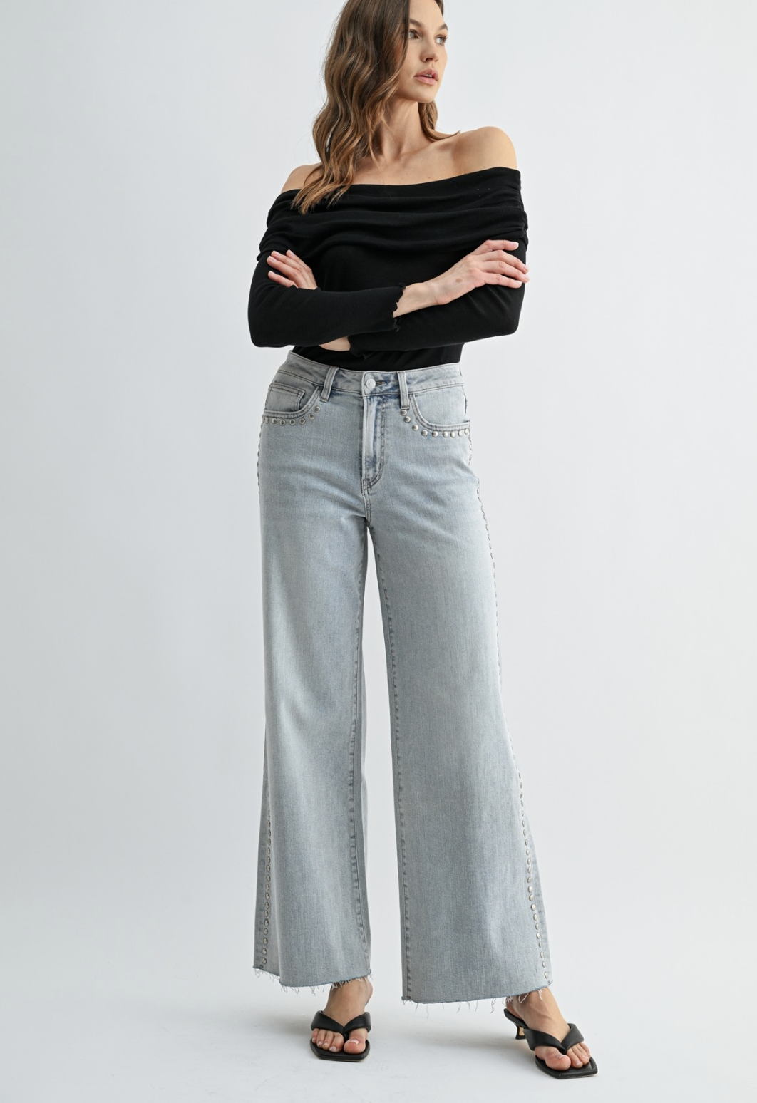 Neptune‑wash raw‑hem studded jeans with soft‑stretch denim and polished‑edgy detailing.