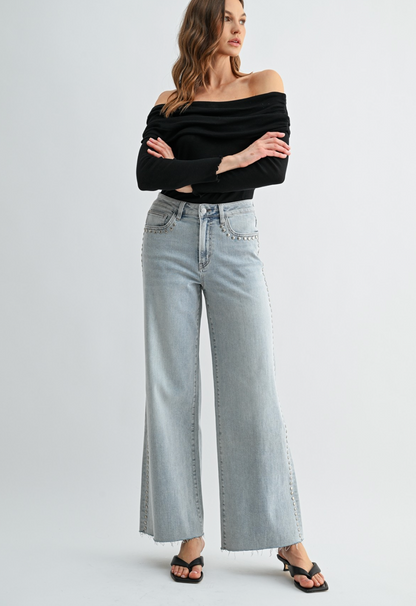 Neptune‑wash raw‑hem studded jeans with soft‑stretch denim and polished‑edgy detailing.