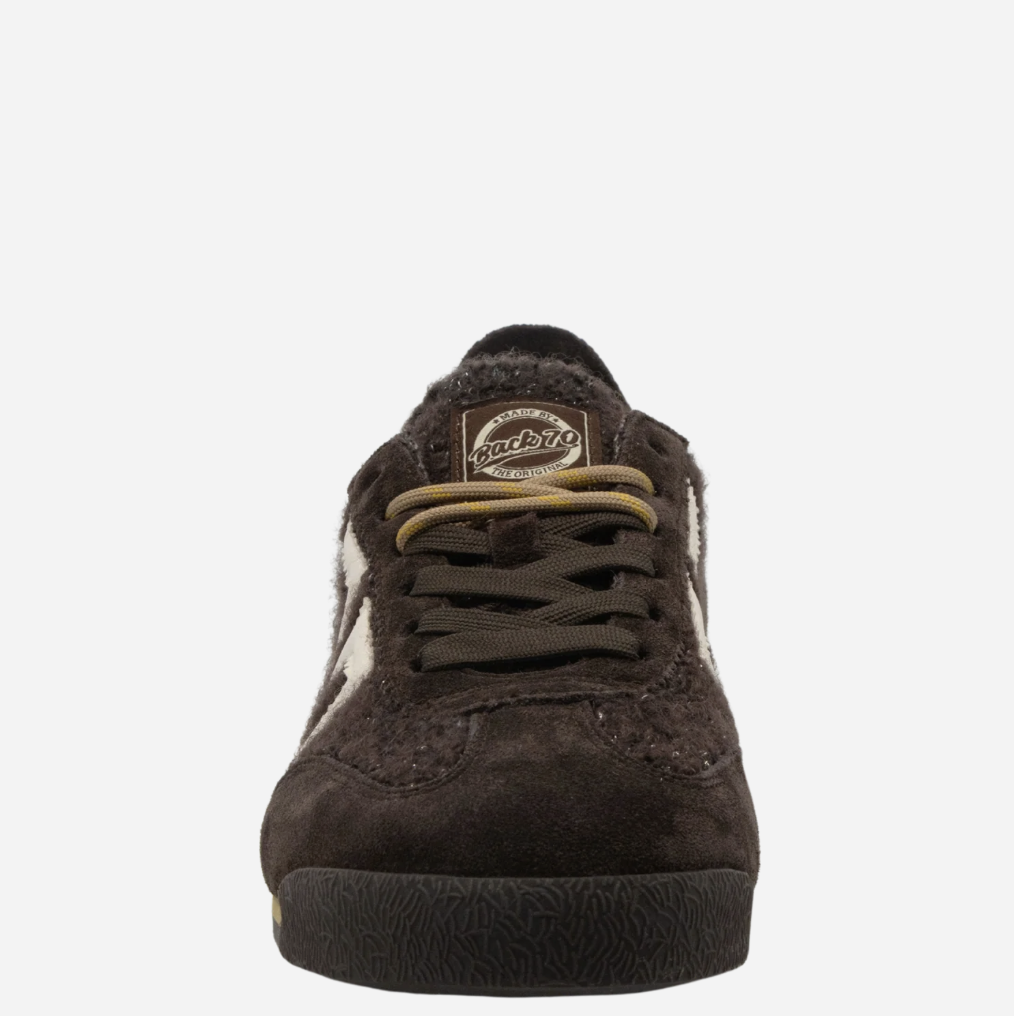 A dark brown suede Back 70 sneaker with a fuzzy brown collar, brown laces, and a circular brown 'Back 70' brand patch on the tongue, shown against a plain white background.