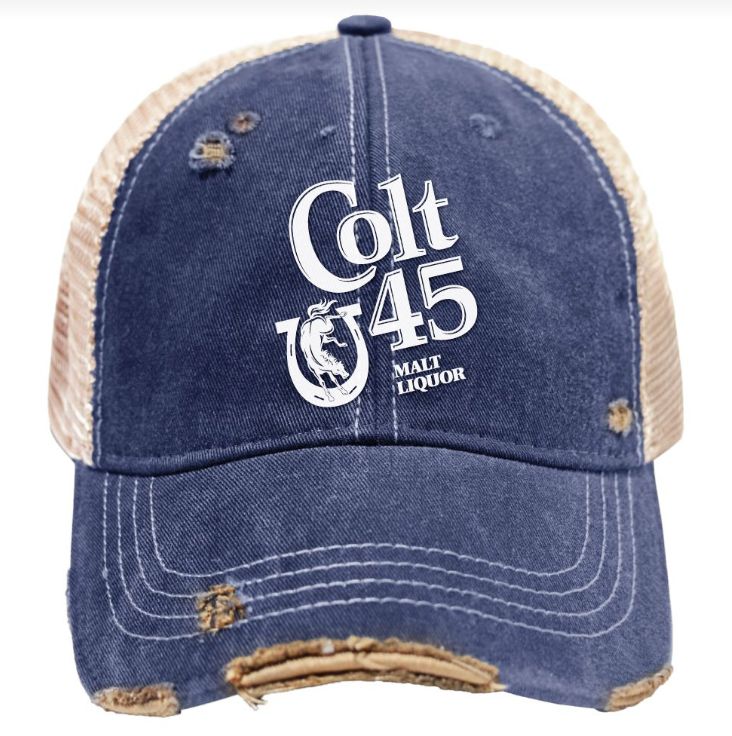 A distressed trucker-style baseball cap featuring a dark blue denim front and brim with tan mesh back panels. The front is printed with a large white 'Colt 45 Malt Liquor' logo and shows intentional frayed detailing around the brim and crown.