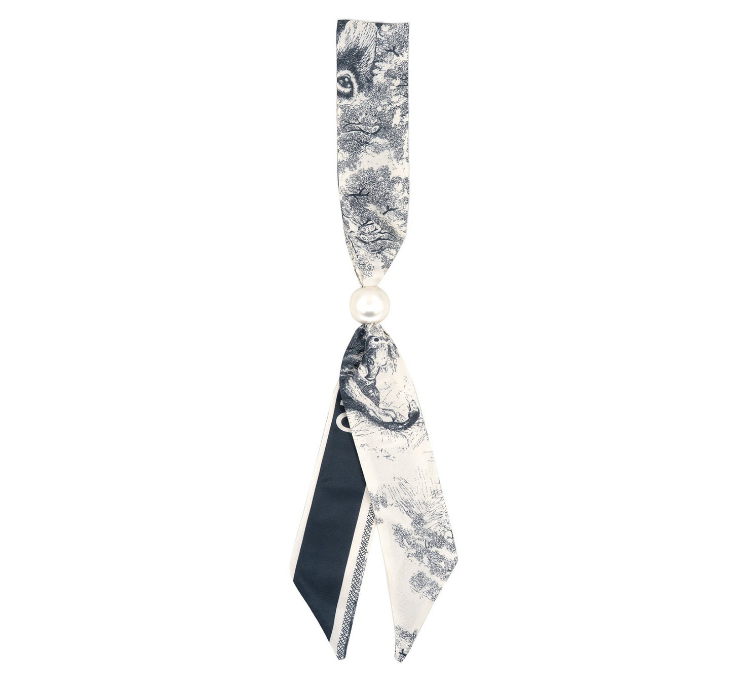 A black and white toile patterned silk ribbon tie with a single white pearl bead at the center, shown against a plain white background.