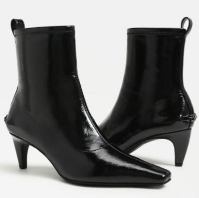 A pair of Circus Inez black patent leather ankle boots with kitten heels, shown from the side against a plain white background.