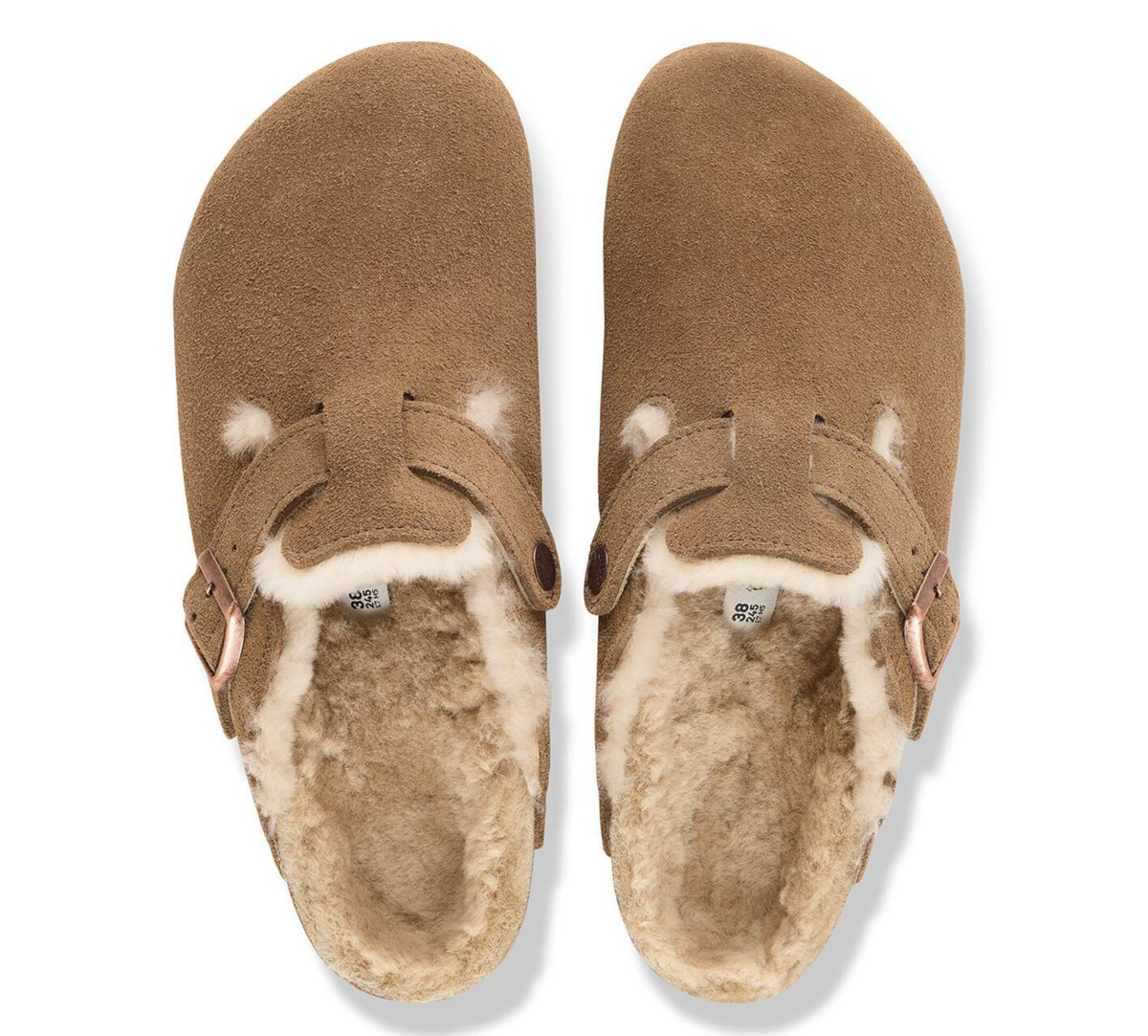 A pair of brown suede Birkenstock clogs with thick cream shearling lining, shown from a top-down view on a white background.