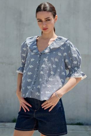 Raisonnel embroidered gingham blouse with lightweight woven fabric and relaxed, feminine silhouette.