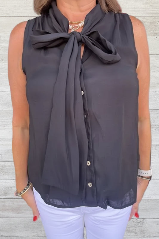 Black tie‑neck button‑down blouse with soft drape and feminine neckline detail.