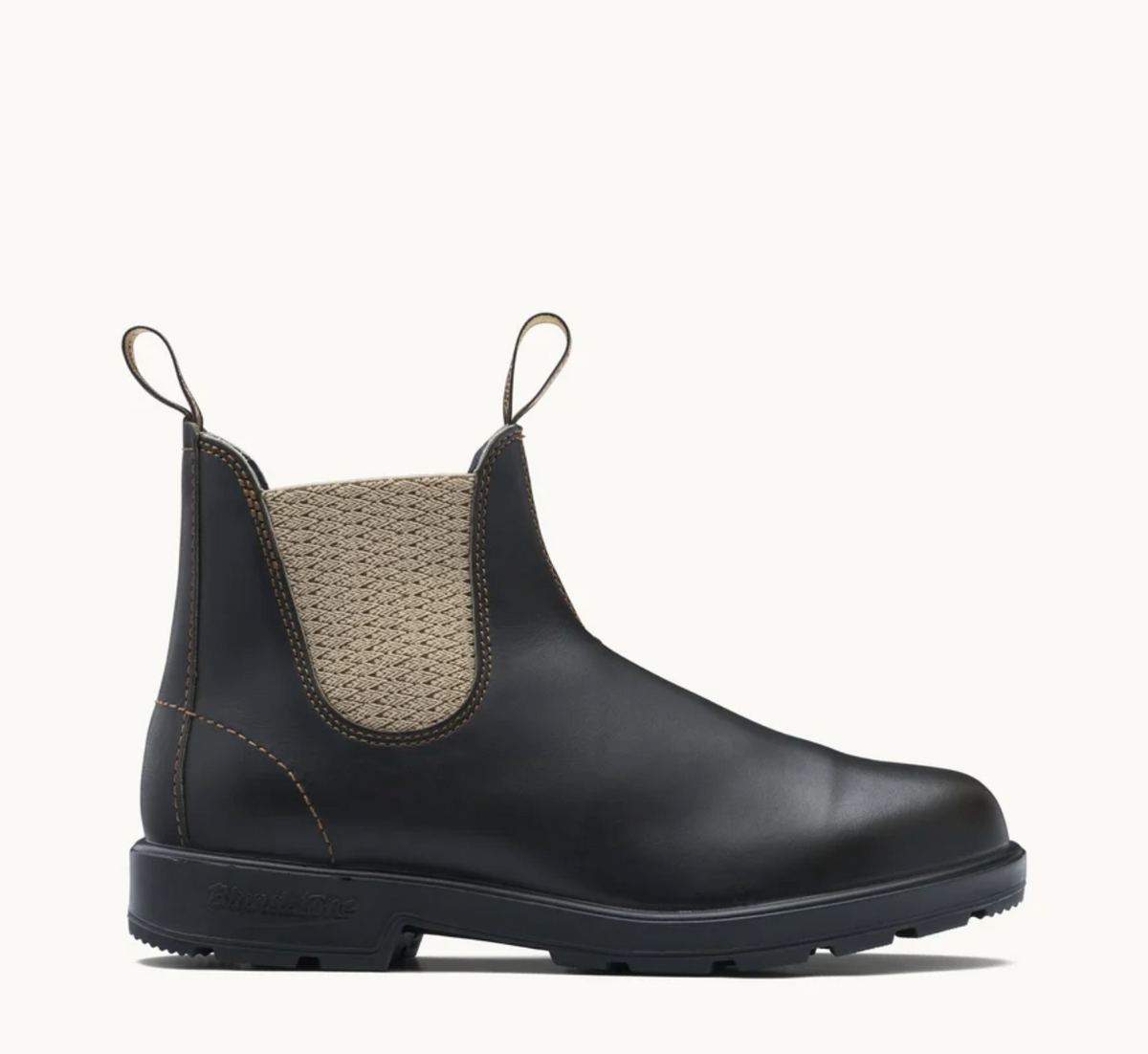 A single Blundstone black leather Chelsea boot with a beige knit elastic side panel and pull tabs, shown in profile against a clean off-white background.
