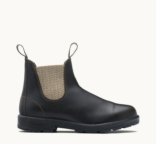 A single Blundstone black leather Chelsea boot with a beige knit elastic side panel and pull tabs, shown in profile against a clean off-white background.