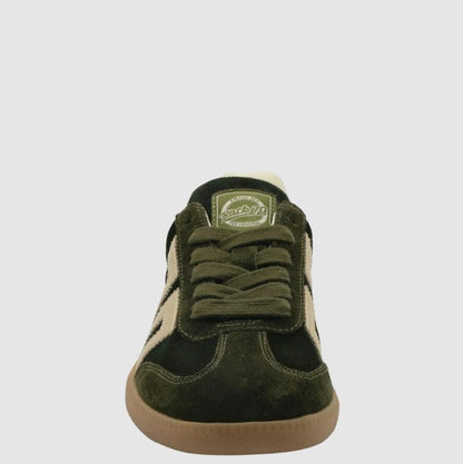A single low-top sneaker shown from the front on a light gray background. The shoe features dark olive green suede panels, beige suede side stripes, matching olive green laces, and a tan gum sole.